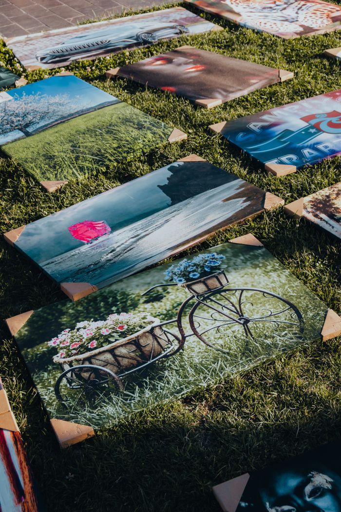 Crafting Captivating Headlines: Your awesome post title goes here Colorful canvas prints laid out on grass, showcasing diverse artistic scenes in natural light.